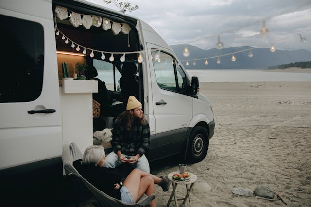 a-couple-sitting-by-an-rv